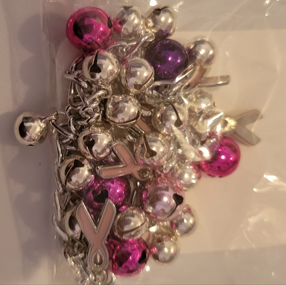 C.A.P Pink,purple, pink ribbon charm bells on bracelet.